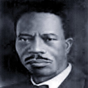 African-American man with mustache in suit and bow tie