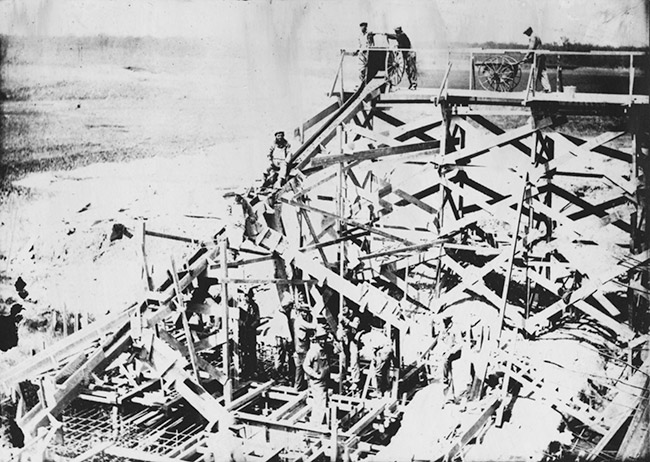 Workers building a dam on river