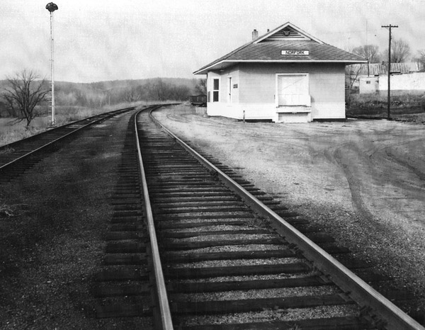 small depot building labeled "Norfork" next to two train tracks