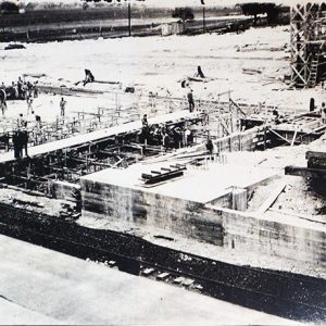 Workers using cement to build a cement factory building