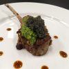 Lamb chop with caviar and pesto on dinner plate