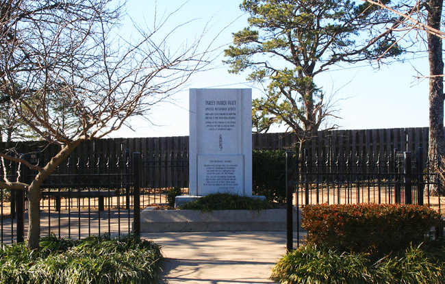 white rectangular stone with "Parley Parker Pratt" at top surrounded by black iron fence