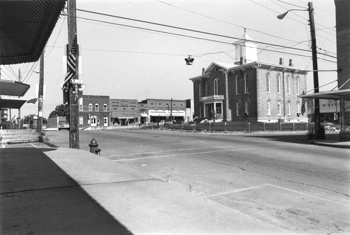 City square with power lines and brick courthouse in center