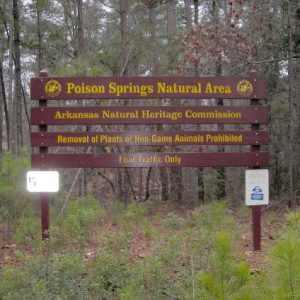 "Poison Springs Natural Area Arkansas Natural Heritage Commission" sign in forest