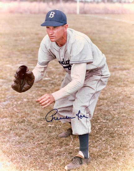 White man crouching with glove in baseball uniform and cap signed "Preacher Roe"