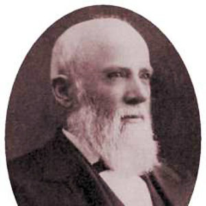 Three quarter view portrait white man with beard suit and tie looking off