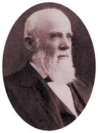 Three quarter view portrait white man with beard suit and tie looking off