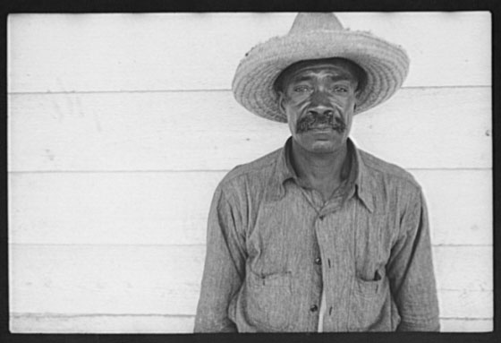 African-American man with mustache in straw hat