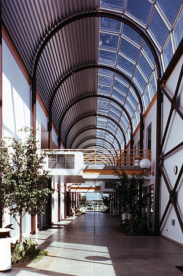 Interior of arched skylight hallway with walking bridges above the floor