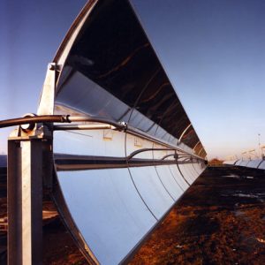 Close-up view of row of curved solar panels in field