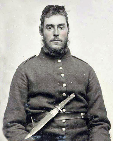 White man with mustache and beard in military uniform with long knife