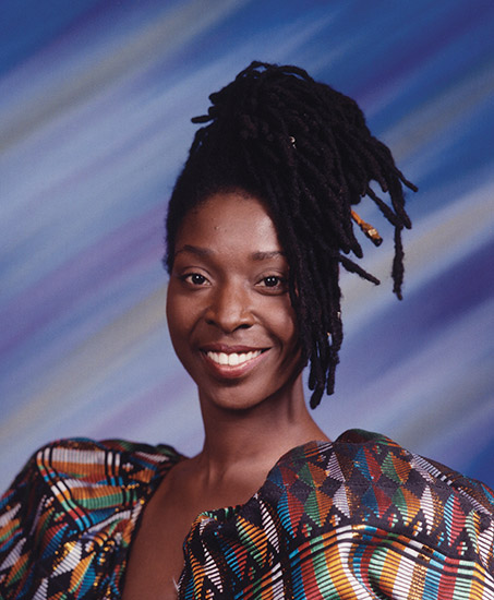 African-American woman smiling in multicolored dress