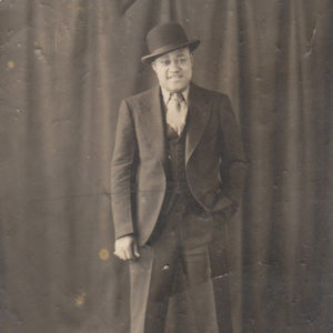 African-American man standing in suit with hat
