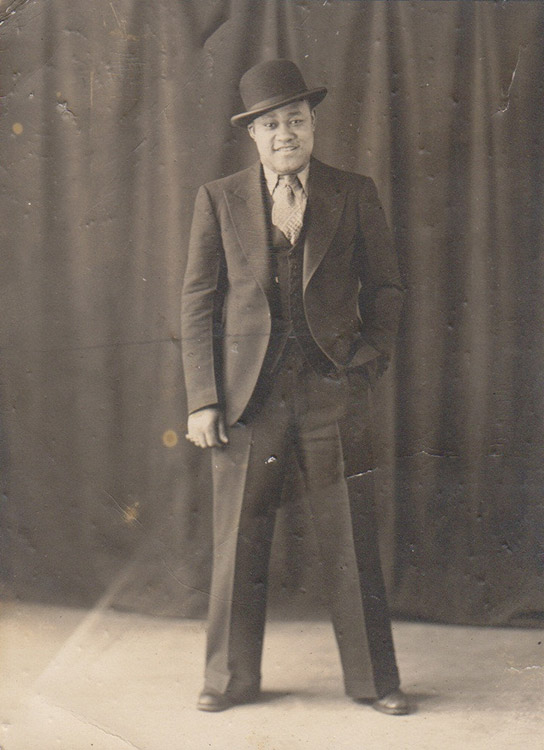 African-American man standing in suit with hat