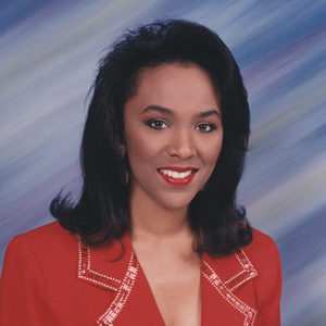 Young African-American woman smiling in red suit and shirt