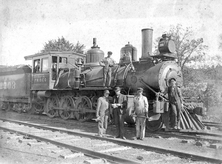 White men posing with a steam locomotive "Frisco"