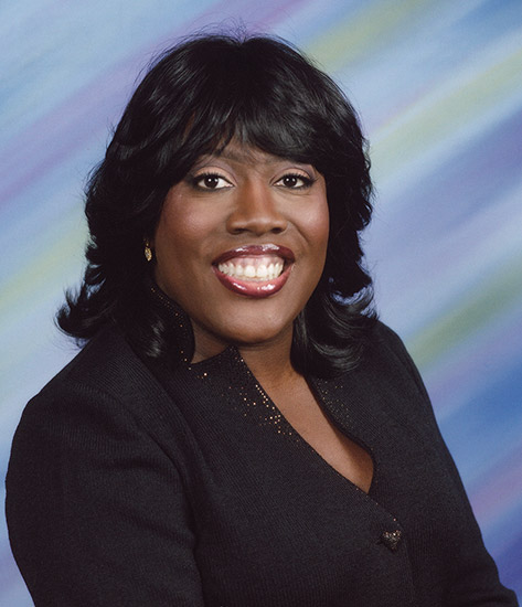 African-American woman smiling in black top