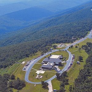 Aerial view mountain geography state park visitor center with surrounding road cars pedestrians