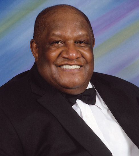 African-American man smiling in tuxedo