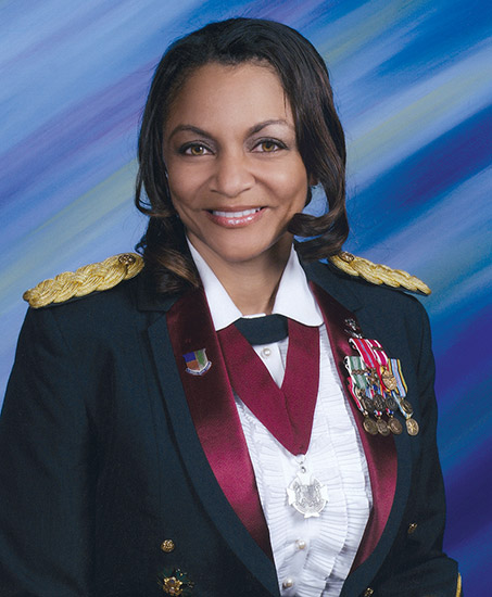 African-American woman smiling in military uniform with medals