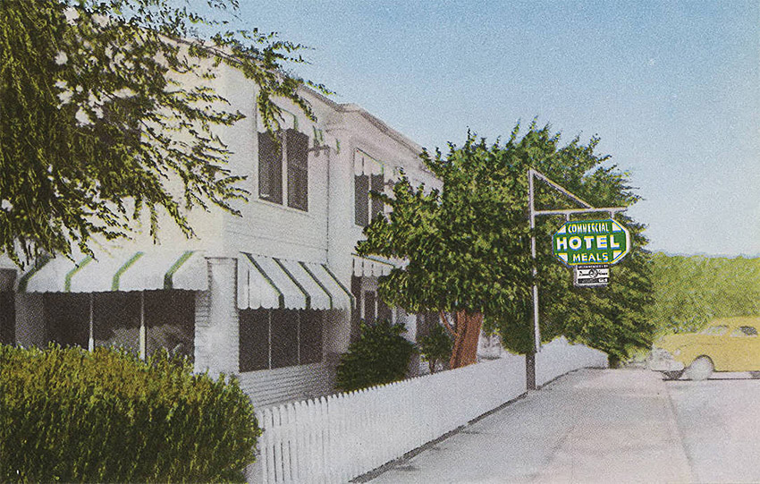 Two-story building with sign "Commercial Hotel"