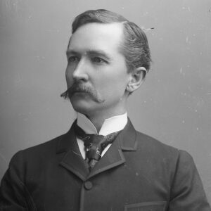 White man in suit and tie with mustache