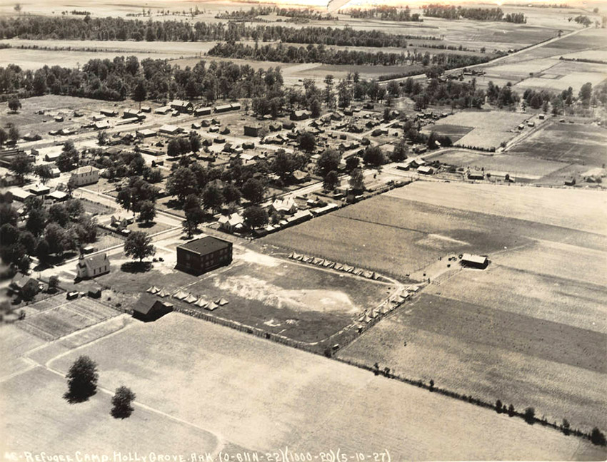 Aerial view of tents amid field near small town