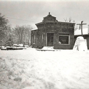 Storefront buildings with street and awnings covered in snow