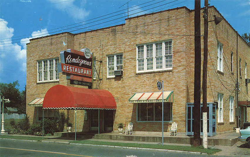 Two story tan brick building with Rendezvous Restaurant sign