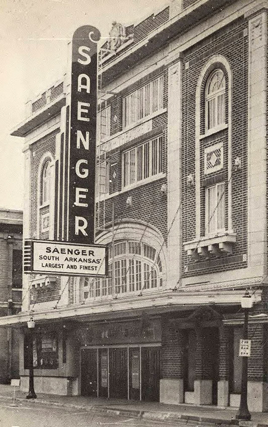 Multistory brick building with theater marquee adorning front