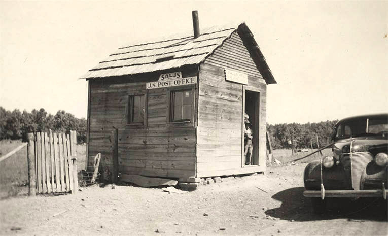 Car parked in front of small wooden shack