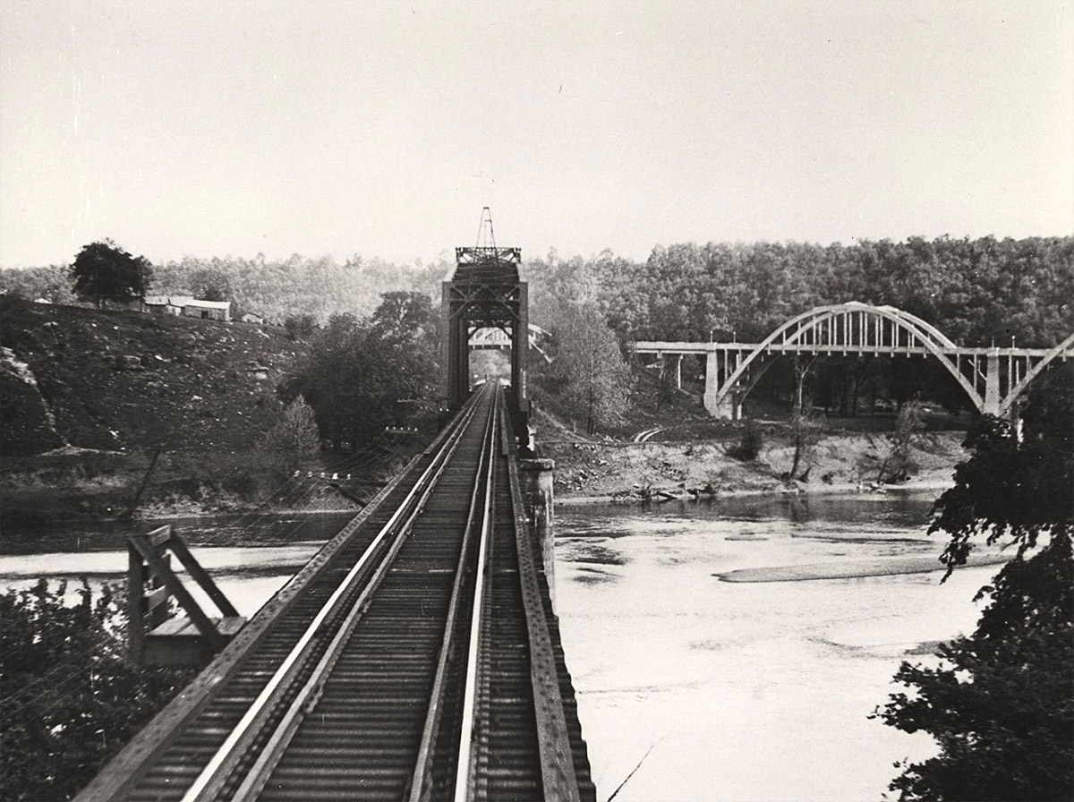 Railroad bridge crossing river; automobile bridge in the distance to the right
