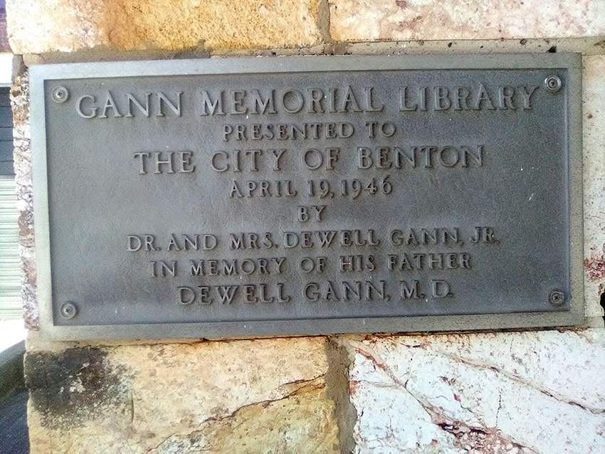 Bronze memorial plaque attached to rock wall