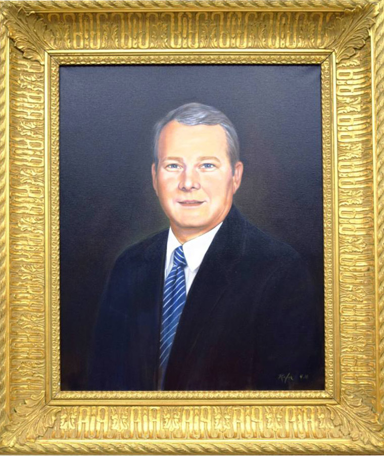 Painting in gold frame of white man in blue suit with striped tie