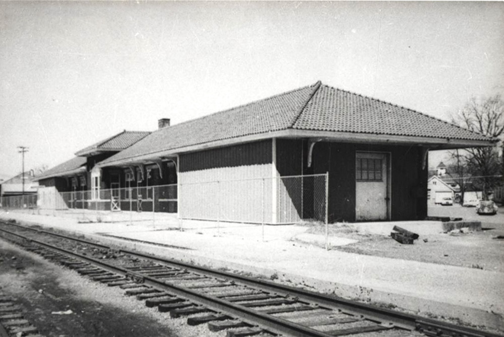 Single story building beside railroad tracks