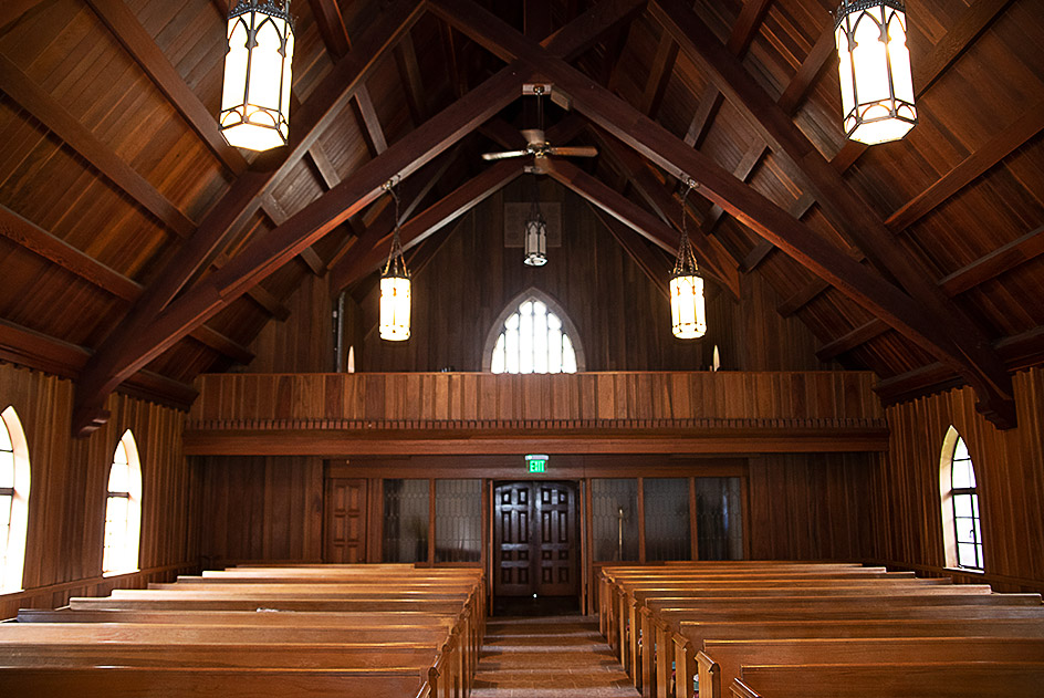 Interior of church building with wooden pews and choir loft