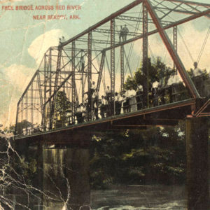 Bridge across river with people standing on it