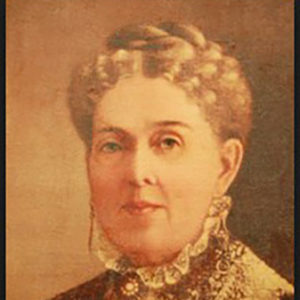 White woman wearing high lace collar and hair up