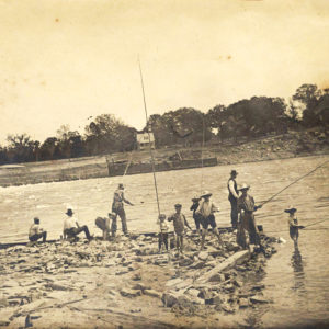 group of men and children fishing in river