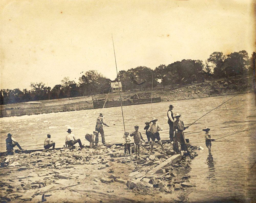 group of men and children fishing in river