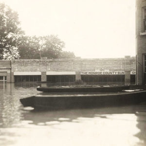 Buildings half underwater with boats in the foreground