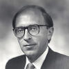 White man in suit and tie wearing glasses