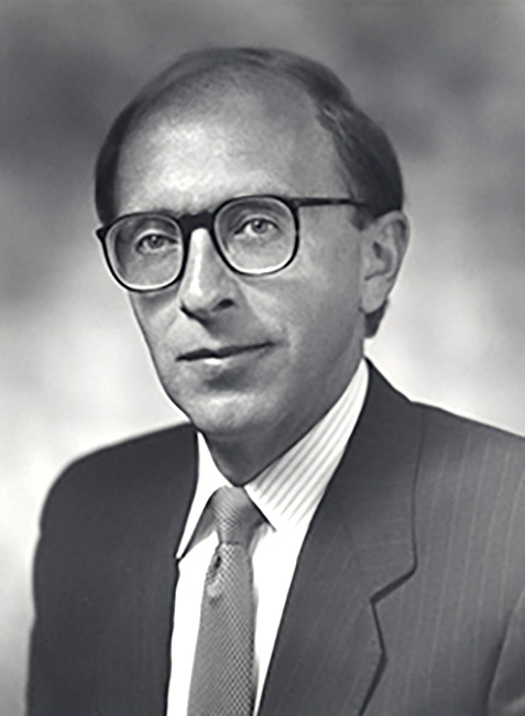 White man in suit and tie wearing glasses