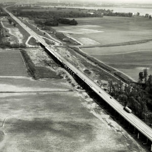 Long highway bridge crossing lowlands and river