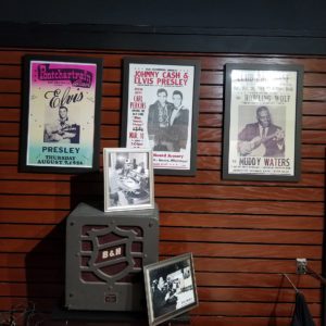 posters of musicians and photos on display