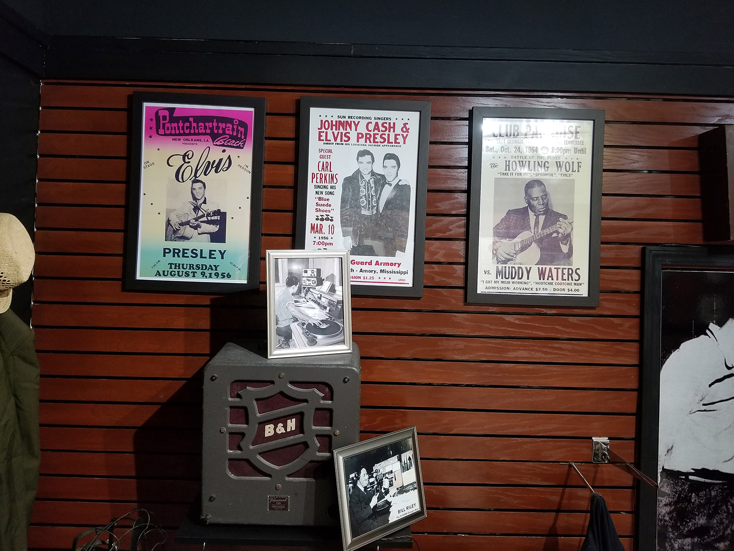 posters of musicians and photos on display