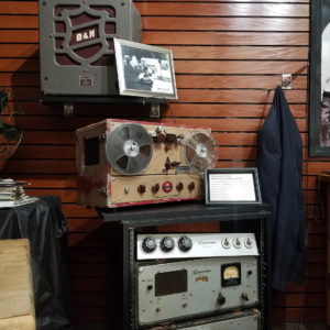radio station broadcasting equipment and photos on display
