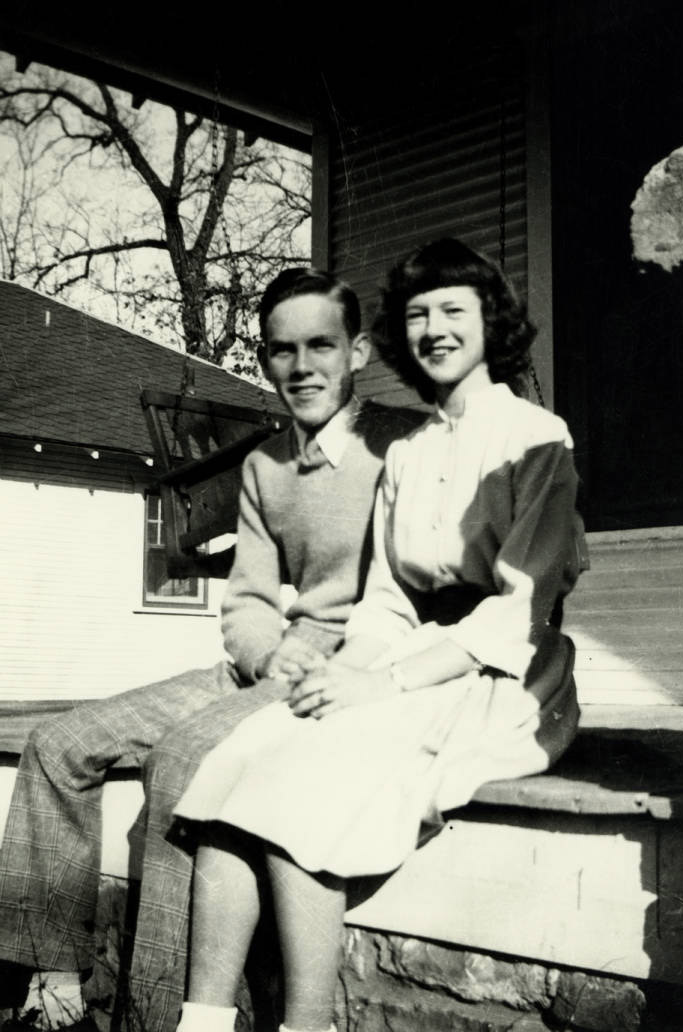 Young man and young woman sitting together on a porch