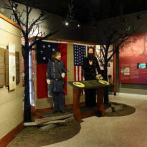 Museum display featuring bearded male mannequins in military garb