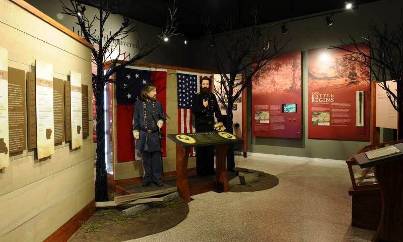 Museum display featuring bearded male mannequins in military garb